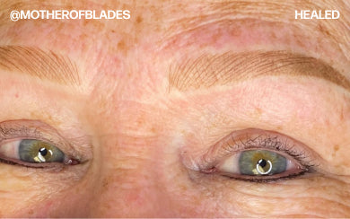 Healed light brown PMU brows with fine hairstrokes on mature skin.