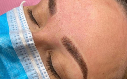 Close-up of a client with freshly tattooed ombre powder brows.